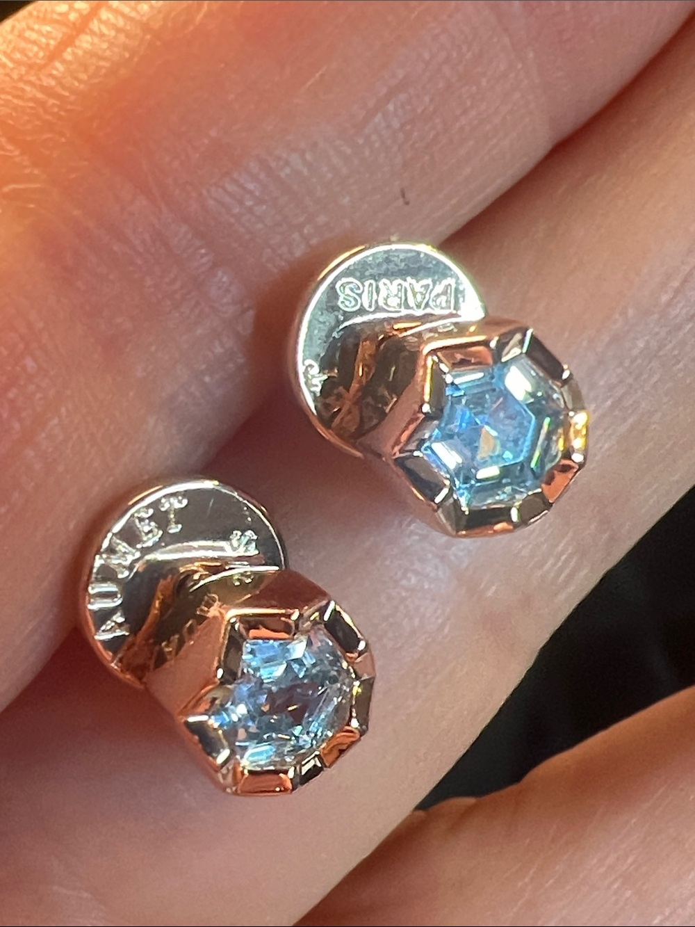 Round Blue Zirconia In a Gold Setting With Logo